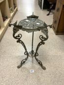 ORNATE BRASS TWO TIER PLANT STAND WITH MASK DECORATION ON HOOF FEET.