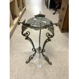 ORNATE BRASS TWO TIER PLANT STAND WITH MASK DECORATION ON HOOF FEET.