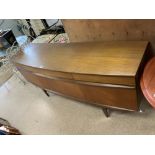 A MID CENTURY TEAK BOW FRONTED SIDEBOARD BY - EON.