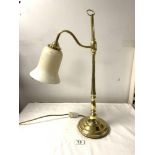 A POLISHED BRASS ADJUSTABLE DESK LAMP WITH A GLASS SHADE. 54CMS.