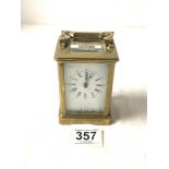 A BRASS CARRIAGE CLOCK WITH WHITE ENAMEL DIAL, [ WORKING ] 12CMS.