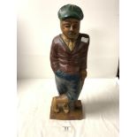 A CARVED AND PAINTED WOODEN FIGURE OF A GOLFER, 46CMS.