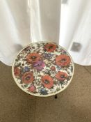 1960S ROUND COFFEE TABLE WITH A POPPY DESIGN TOP ON THREE SPLAYED LEGS