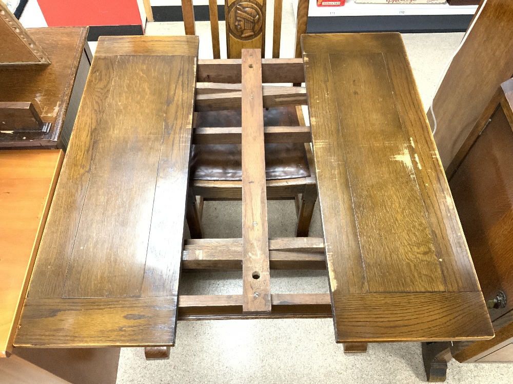 A 1940s OAK DINING SUITE WITH CARVED HEAD MOTIFS DECORATION - INCLUDES A DRAW LEAF TABLE, FOUR - Image 6 of 12