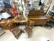 A 1940s OAK DINING SUITE WITH CARVED HEAD MOTIFS DECORATION - INCLUDES A DRAW LEAF TABLE, FOUR