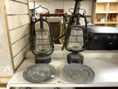 TWO VINTAGE METAL OIL LANTERNS, AND A PAIR OF EMBOSSED PEWTER PLATES.