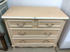 A DE TONGE FRENCH MADE PEACH AND WHITE PAINTED FOUR DRAWER CHEST OF DRAWERS, ON CABRIOLE LEGS,