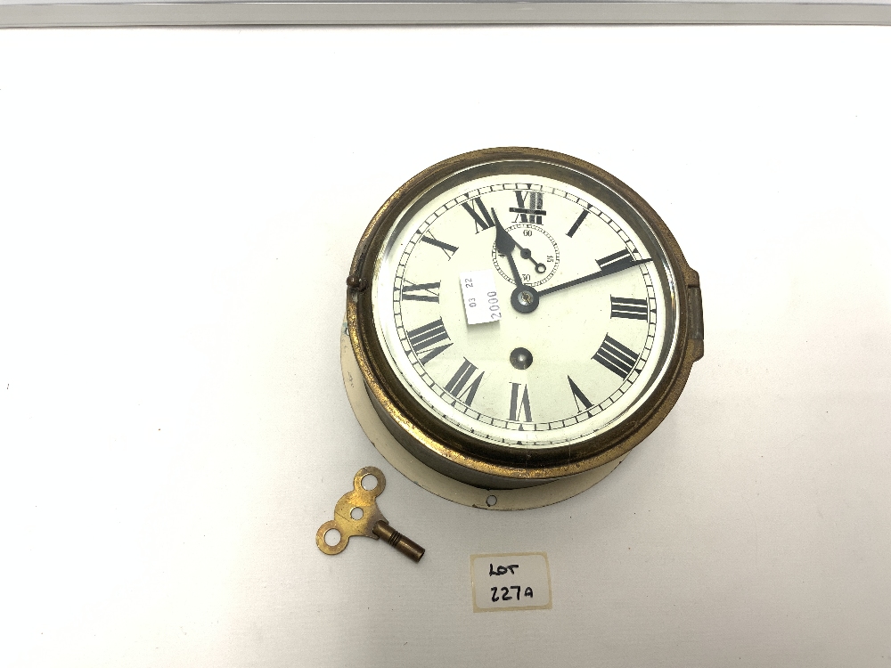 A BRASS SHIPS CLOCK, WITH PAINTED DIAL, AND SUBSIDERY DIAL, 17CMS DIAMETER.