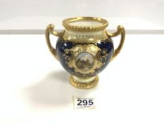 A COALPORT PORCELAIN TWO HANDLED VASE, BLUE AND GILT DECORATED, WITH A HAND PAINTED CENTRAL SCENE OF