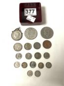 A 1964 HALF DOLLAR COIN AND SMALL QUANTITY OF FOREIGN COINS.