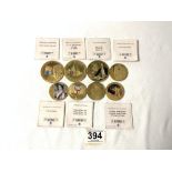 TEN GOLD PLATED COMMEMORATIVE COINS - VARIOUS.