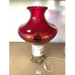 A GLASS AND GILT METAL OIL STYLE LAMP FOR ELECTRICITY, WITH A RUBY GLASS SHADE, APPROX 55 CMS.