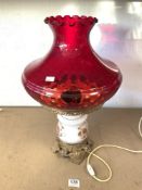 A GLASS AND GILT METAL OIL STYLE LAMP FOR ELECTRICITY, WITH A RUBY GLASS SHADE, APPROX 55 CMS.