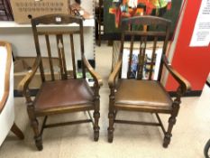 A PAIR OF 1930s OAK ELBOW CHAIRS ON TURNED LEGS.