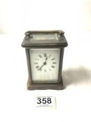 A BRASS CARRIAGE CLOCK WITH WHITE ENAMEL DIAL, [ WORKING ORDER AND KEY ]. 11.5 CMS.