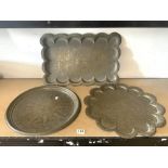 THREE INDIAN ENGRAVED BRASS TRAYS, TWO SHAPED AND ONE CIRCULAR, 46 CMS DIAMETER.
