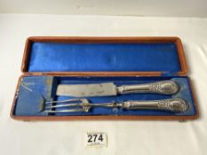 A NINETEENTH CENTURY FRENCH SILVER HANDLED CARVING KNIFE AND FORK IN FITTED LEATHER CASE.