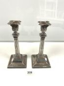 A PAIR OF SQUARE SILVER-PLATED CORINTHIAN COLUMN CANDLESTICKS, 28 CM.