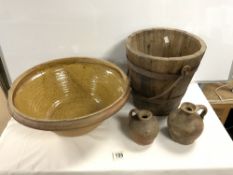 A GLAZED STONEWARE CREAM BOWL, 46 CMS, A VINTAGE WOODEN WATER BUCKET AND TWO STONEWARE JUGS,
