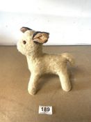A VINTAGE STRAW-FILLED TOY LAMB WITH GLASS EYES.