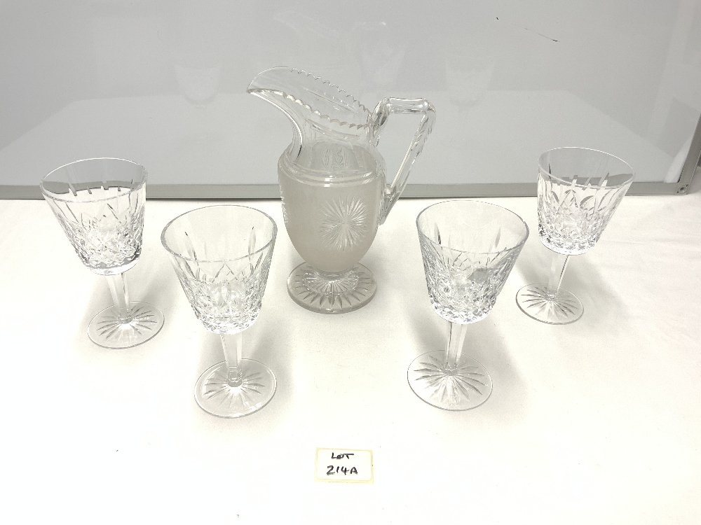 FOUR WATERFORD CUT GLASS WINE GLASSES, AND A FROSTED GLASS WATER JUG.