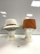 A VINTAGE PITH HELMET AND A FEZ HAT.