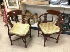 A PAIR OF CHINESE HARDWOOD CORNER CHAIRS WITH CARVED SLAT SUPPORTS, WITH ORIGINAL CUSHIONS.
