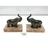 A PAIR OF FRENCH ART DECO ELEPHANT BOOKENDS ON MARBLE BASES.