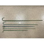 FOUR GLASS TWIST WALKING CANES, TWO WITH BLOWN GLASS TOPS.
