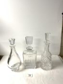 A WATERFORD CUT CRYSTAL GLASS BELL SHAPE DECANTER, 34 CMS, AND TWO OTHER GLASS DECANTERS.