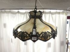 A LATE VICTORIAN TIFFANY STYLE SLAG GLASS AND ORNATE METAL CEILING LIGHT, 55CMS DIAMETER.