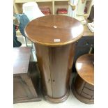 A CYLINDRICAL MAHOGANY STORAGE CABINET WITH INTERIOR SHELVES, 50 CMS DIAMETER, 122 CMS TALL..