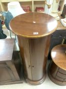 A CYLINDRICAL MAHOGANY STORAGE CABINET WITH INTERIOR SHELVES, 50 CMS DIAMETER, 122 CMS TALL..