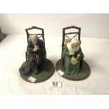 A PAIR OF WOODEN AND COMPOSITE NODDING FIGURES OF ELDERLY MAN AND LADY IN CHAIRS.