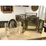 A GILT TRIPLE FOLDING DRESSING TABLE MIRROR, AND OVAL EMBOSSED TRIPLE FOLDING MIRROR.