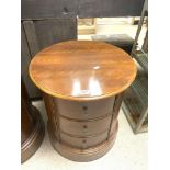 A CYLINDRICAL MAHOGANY THREE DRAWER BEDSIDE CHEST OF DRAWERS, 54 CMS DIAMETER X 60 CMS TALL.