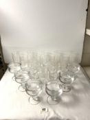 A SET OF TWELVE ETCHED GLASS LONG DRINKING GLASSES, AND SET OF SIX ENGRAVED SUNDAE GLASSES.