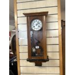 A LATE VICTORIAN WALNUT VIENNA WALL CLOCK, WITH CIRCULAR ENAMEL DIAL.