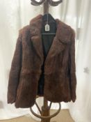 A BROWN FUR COAT, SIZE 14,