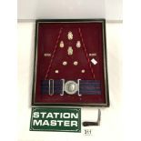 A ROYAL ARMY ORDNANCE CORPS BELT, BADGE AND BUTTON DISPLAY, AND ENAMEL STATION MASTER SIGN, AND