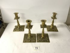 A SET OF FOUR VICTORIAN (CAST BRASS) PIERCED SQUARE CANDLESTICKS, 18 CM.