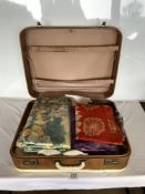 A SUIT CASE OF MATERIAL, INCLUDES TABLE CLOTHES AND MORE.