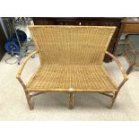 A WICKER TWO SEATER CONSERVATORY CHAIR.