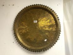 A CIRCULAR EASTERN BRASS TRAY WITH ENGRAVED DECORATION AND PIERCED BORDER, 60 CM DIAMETER.