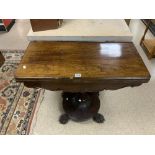 EARLY VICTORIAN ROSEWOOD CARD TABLE ON CIRCULAR BASE WITH CLAW FEET.