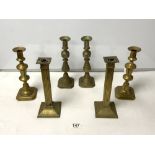 A PAIR OF BRASS SQUARE REEDED DESIGN CANDLESTICKS, 26 CMS, AND TWO PAIRS OF VICTORIAN BRASS BALUSTER