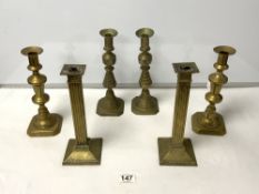 A PAIR OF BRASS SQUARE REEDED DESIGN CANDLESTICKS, 26 CMS, AND TWO PAIRS OF VICTORIAN BRASS BALUSTER