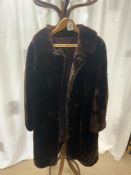 A BROWN FUR COAT WITH SILK LINING.