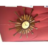 A MID-CENTURY WOODEN SUNBURST WALL CLOCK, CONVERTED TO BATTERY MOVEMENT.