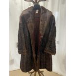 A TWO COLOUR DARK BROWN FUR COAT.